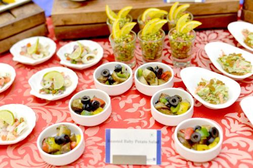 a table topped with dishes of food on a table at Radisson Blu Hotel Guwahati in Guwahati