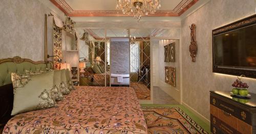 a bedroom with a bed and a television in it at Radisson Blu MBD Hotel Noida in Noida