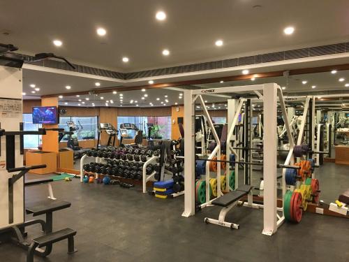 a gym with lots of treadmills and machines at Radisson Blu MBD Hotel Noida in Noida