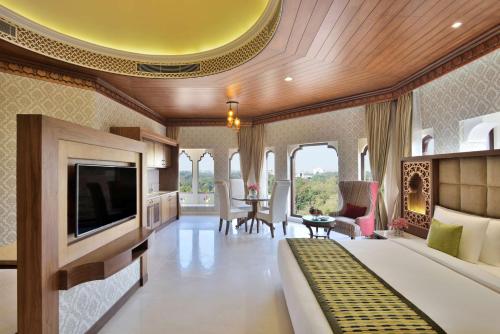 a hotel room with a bed and a television at Radisson Jodhpur in Jodhpur