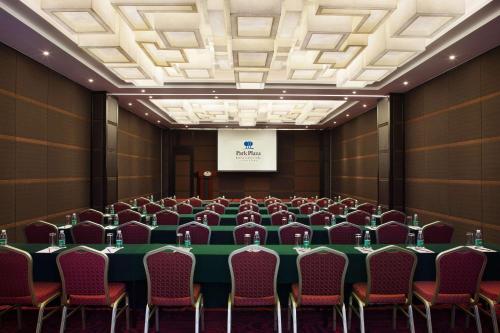 a conference room with a green table and chairs at Park Plaza Beijing Science Park in Beijing