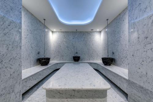 a room with a bench in the middle of a room at Radisson Blu Hotel Istanbul Ottomare in Istanbul