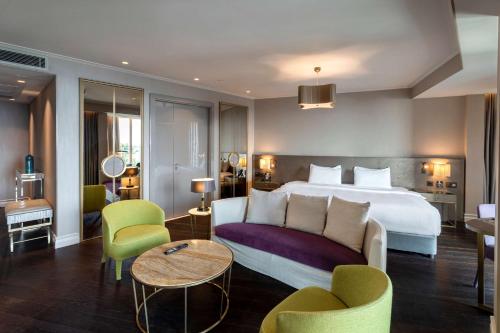 a hotel room with a bed and a table and chairs at Radisson Blu Hotel Istanbul Ottomare in Istanbul