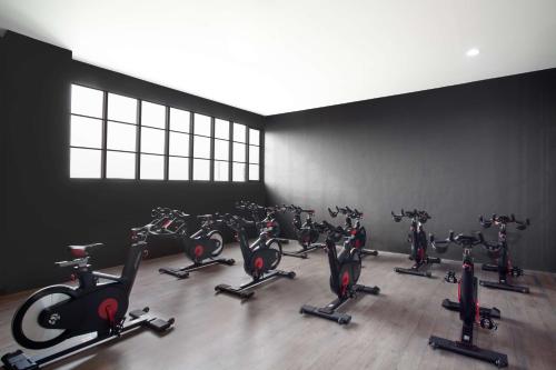 a gym with a bunch of exercise bikes at Radisson Lampung Kedaton in Bandar Lampung