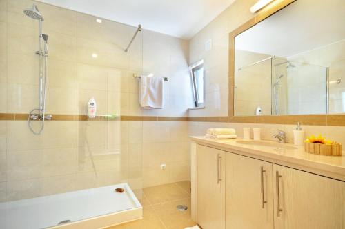 a bathroom with a shower and a sink and a tub at Casa da Ribeira in Silves