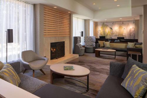 a living room with a couch and a fireplace at Sonesta Select Chattanooga Hamilton Place in Chattanooga