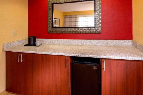 a bathroom with a counter top and a mirror at Sonesta Select Durham Research Triangle Park in Durham