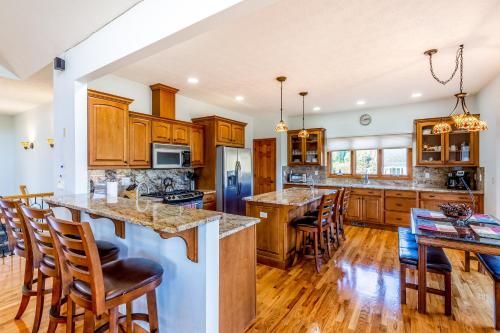 a kitchen with wooden cabinets and a island with bar stools at Everview in Waynesville