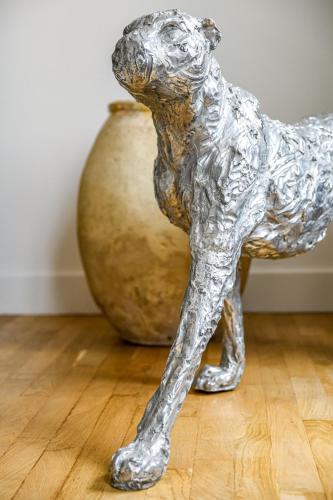a silver statue of a dog standing next to a vase at La Maison de Reina in Troyes