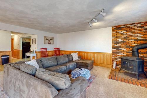 a living room with a couch and a fireplace at White Mountain Getaway in Bartlett