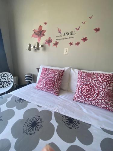 a bedroom with a bed with pink and white pillows at National Park Alpine Lodge in National Park