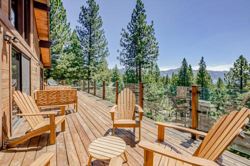 a wooden deck with chairs and a table at Over the Moon in Incline Village