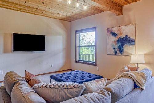 a living room with a large couch and a tv at Over the Moon in Incline Village