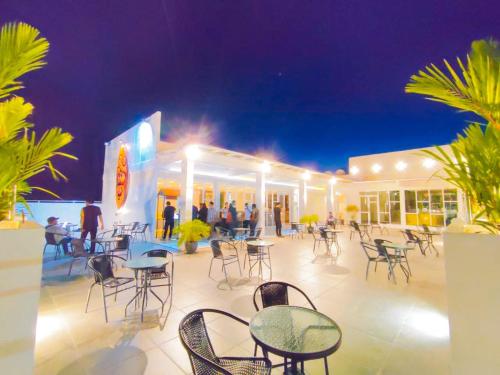 a patio with tables and chairs in front of a building at Front One Budget Waena Abepura in Abepura