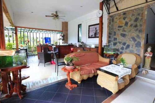 a living room with a couch and a table at Platinum Place in Bangkok