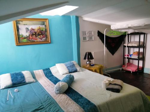 a bedroom with a large bed with a blue wall at AL- Almada 4 in Porto