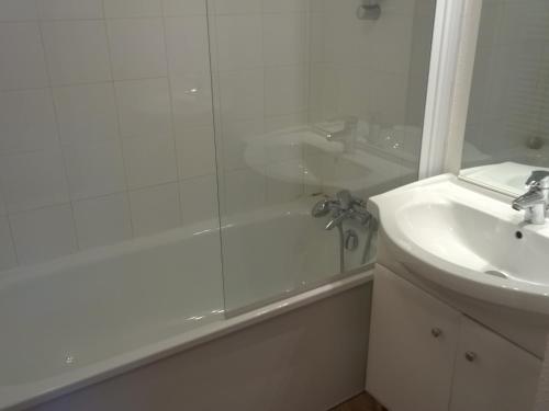a white bathroom with a shower and a sink at Appartement Saint-François-Longchamp, 2 pièces, 4 personnes - FR-1-635-40 in Saint-François-Longchamp