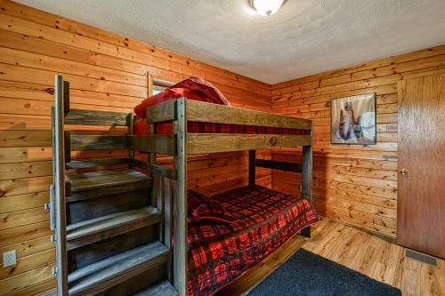 a bedroom with two bunk beds in a log cabin at Gleanings Pond in McHenry