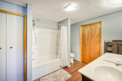 a bathroom with a tub and a sink and a toilet at Gleanings Pond in McHenry