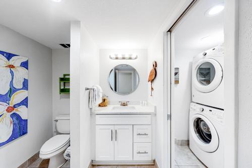 a white bathroom with a washer and dryer at Bayou Village 610 in Destin