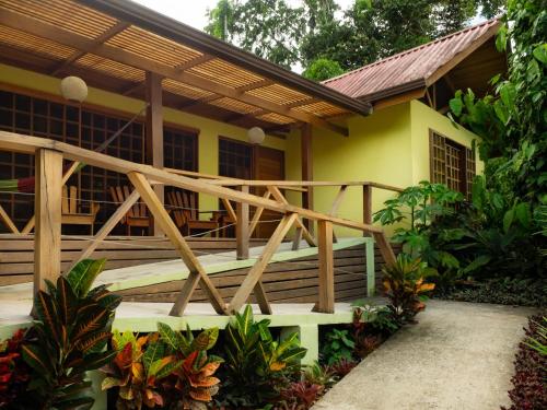 a house with a wooden deck in front of it at Las Palomas Villas in Cocles