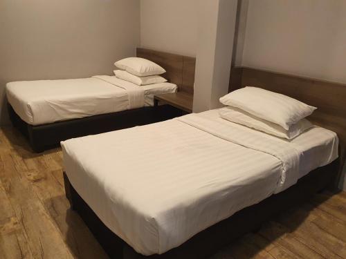 Postel nebo postele na pokoji v ubytování See Foo Hotel