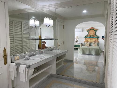 a bathroom with two sinks and a large mirror at VILLA JADE LUXURY FULL SERVICE STAFF VILLA in Acapulco
