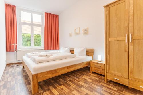 ヴェルニゲローデにあるWR Rote Ferienwohnung in der alten Apothekeの大きなベッドと窓のある寝室