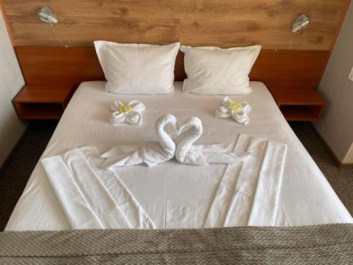 a bed with two towels and two hearts on it at Sea Horse in Burgas City