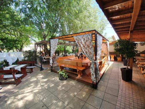a pavilion with a wooden table and a wooden at Sea Horse in Burgas City