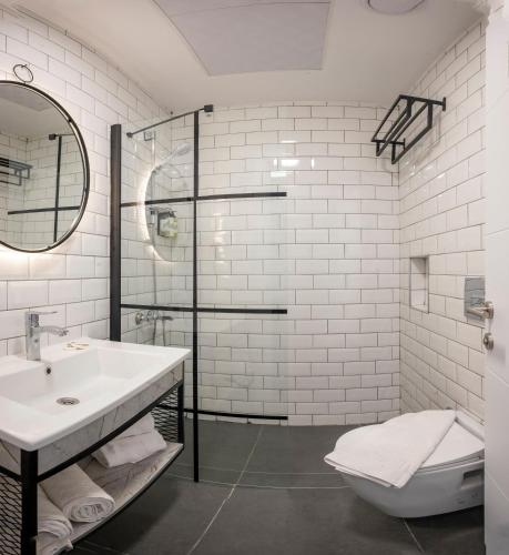 a bathroom with a sink and a toilet and a shower at Seyithan Palace Hotel in Istanbul