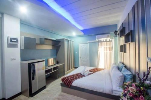 a bedroom with a bed in a blue room at Supreme Place SHA Plus in Khon Kaen