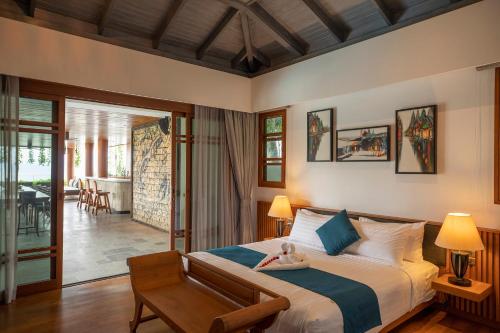 a bedroom with a bed with a doll laying on it at Rachawadee Surin Beach-SHA Extra Plus in Surin Beach