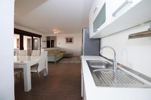 a kitchen and living room with a sink and a table at Janino Murter in Murter