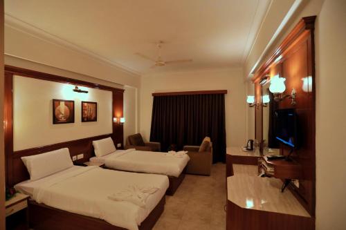 Ένα ή περισσότερα κρεβάτια σε δωμάτιο στο Hotel Edassery Mansion