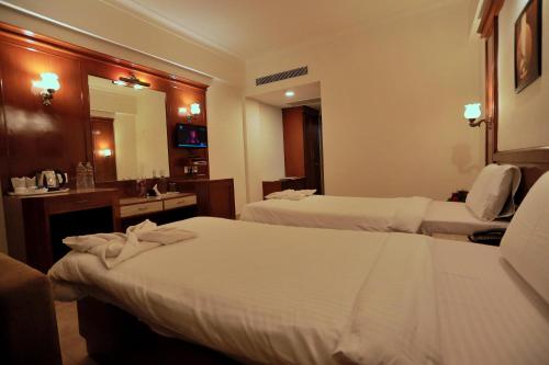Ένα ή περισσότερα κρεβάτια σε δωμάτιο στο Hotel Edassery Mansion