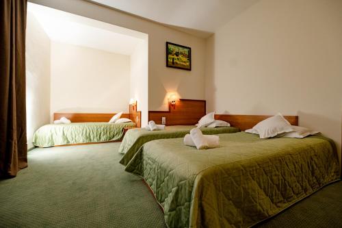 Säng eller sängar i ett rum på Hotel Rivulus