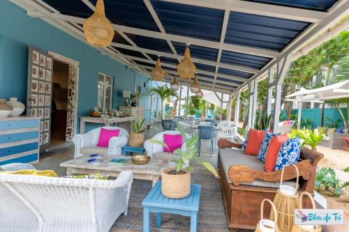 
a living room filled with furniture and a patio at Bleu de Toi Boutique Guesthouse in Pereybere
