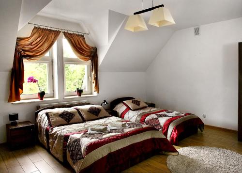 a bedroom with two beds and a window at Wodnik in Krosno