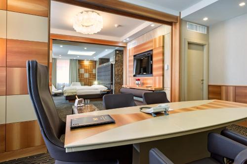 a room with a table and chairs and a bedroom at Hotel St.Gotthard in Zürich