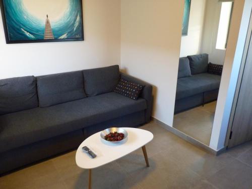 a living room with a couch and a table at Comfort Suites & Rooms in Larisa
