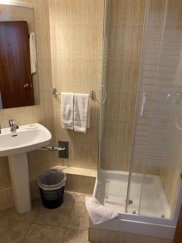 a white toilet sitting next to a shower in a bathroom at Hotel Copacabana in Pas de la Casa