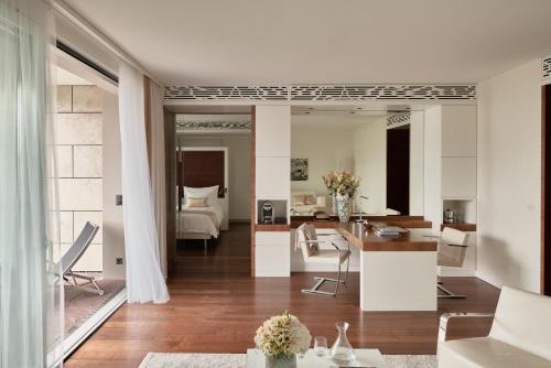 a living room with white furniture and a dining room at Grand Resort Bad Ragaz in Bad Ragaz