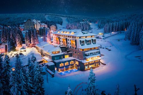 a house in the snow at night with christmas lights at Gorski Hotel & Spa in Kopaonik