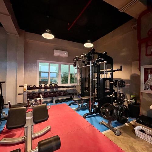 a room with a gym with chairs and a red carpet at Ciabel Hotel and Fitness Center in San Juan