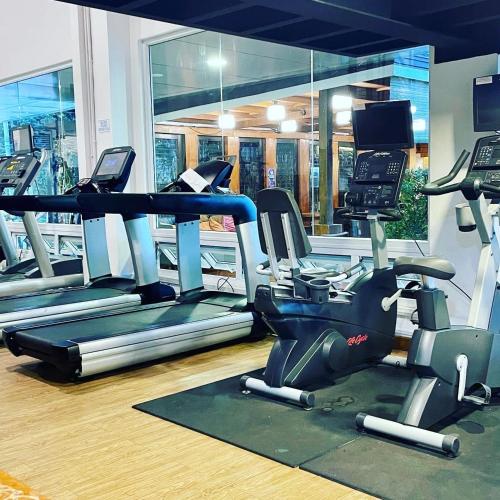 a gym with treadmills and elliptical machines at Ciabel Hotel and Fitness Center in San Juan