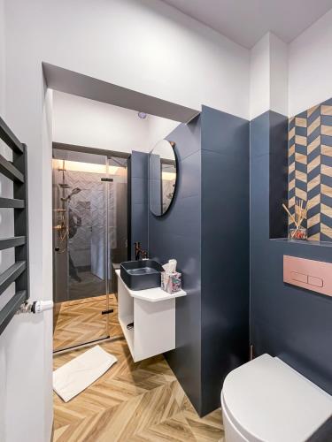 a bathroom with a toilet and a sink at RoomService in Bielsko-Biała