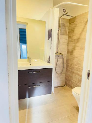 a bathroom with a sink and a shower at aday - Central cozy and bright apartment in Aalborg