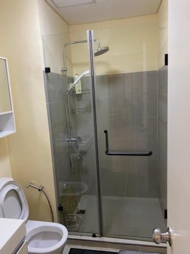 a shower stall in a bathroom with a toilet at Pico de Loro 2BR Vacation Flat in Nasugbu