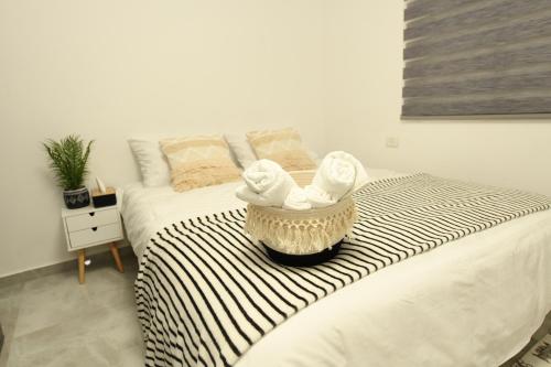 a bed with a pair of white shoes on it at MAKAZA neviot in Eilat